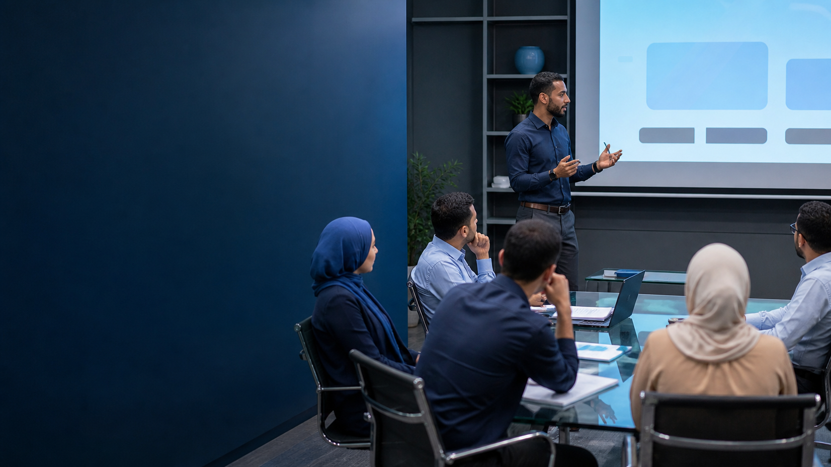 A corporate training workshop with a facilitator presenting to professionals